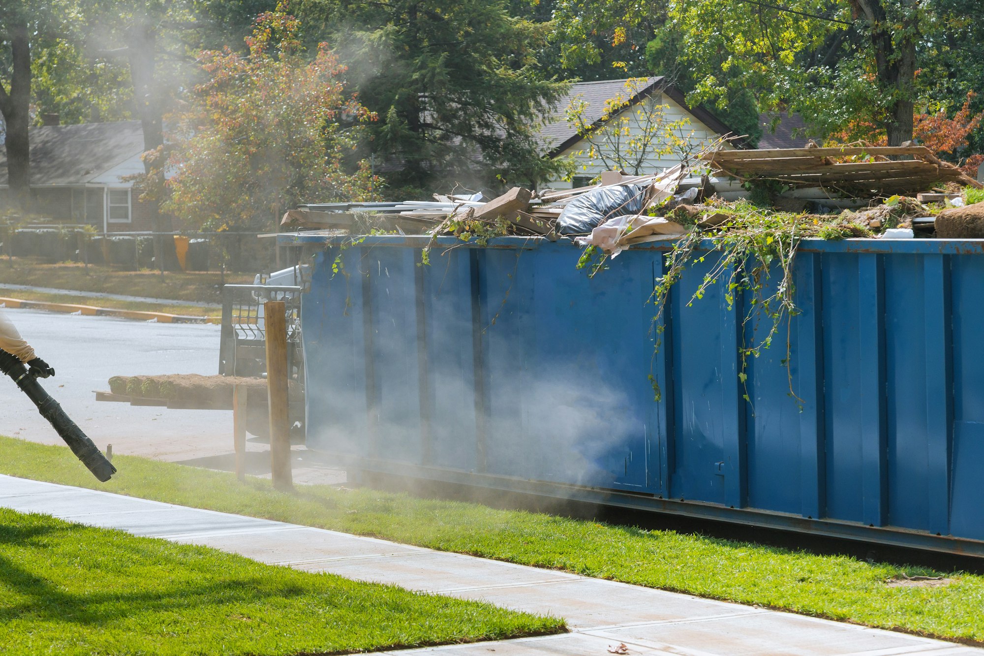 Lawn grass in rolls on pallets against of the street the rolled grass lawn ready for laying and